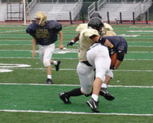 Justin Colbaugh (LB) tackles a Butler player in the open field.