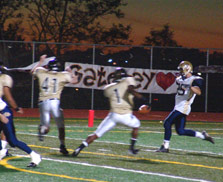 Justin Colbaugh sacks QB Rometo at the 1 with Loheyde and Kwaitkowski nearby.