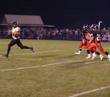Justin King peeks back at a host of Latrobe defenders on his way to a 60 yard TD run