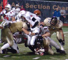 Justin Colbaugh #9 CRUNCHES the stomach of Fox Chapel QB Michael Murray, knocking the ball loose