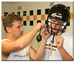 Dan Loheyde gets fitted for his helmet by Wiz