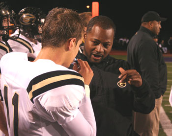 Head Coach Terry Smith talking to Freshman QB Robbie Kalkstein